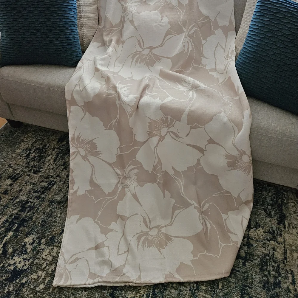 Floral tan and ivory fabric shower curtain with satin nickel hooks.